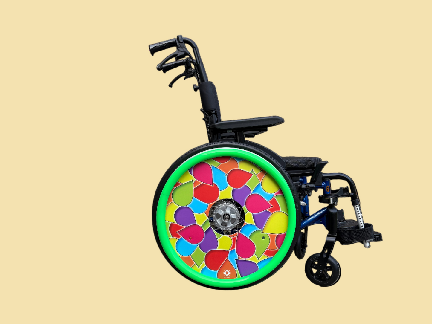 Wheelchair with celebrations spoke guard cover, which is covered in multi coloured balloons. With matching bright green push rim cover.