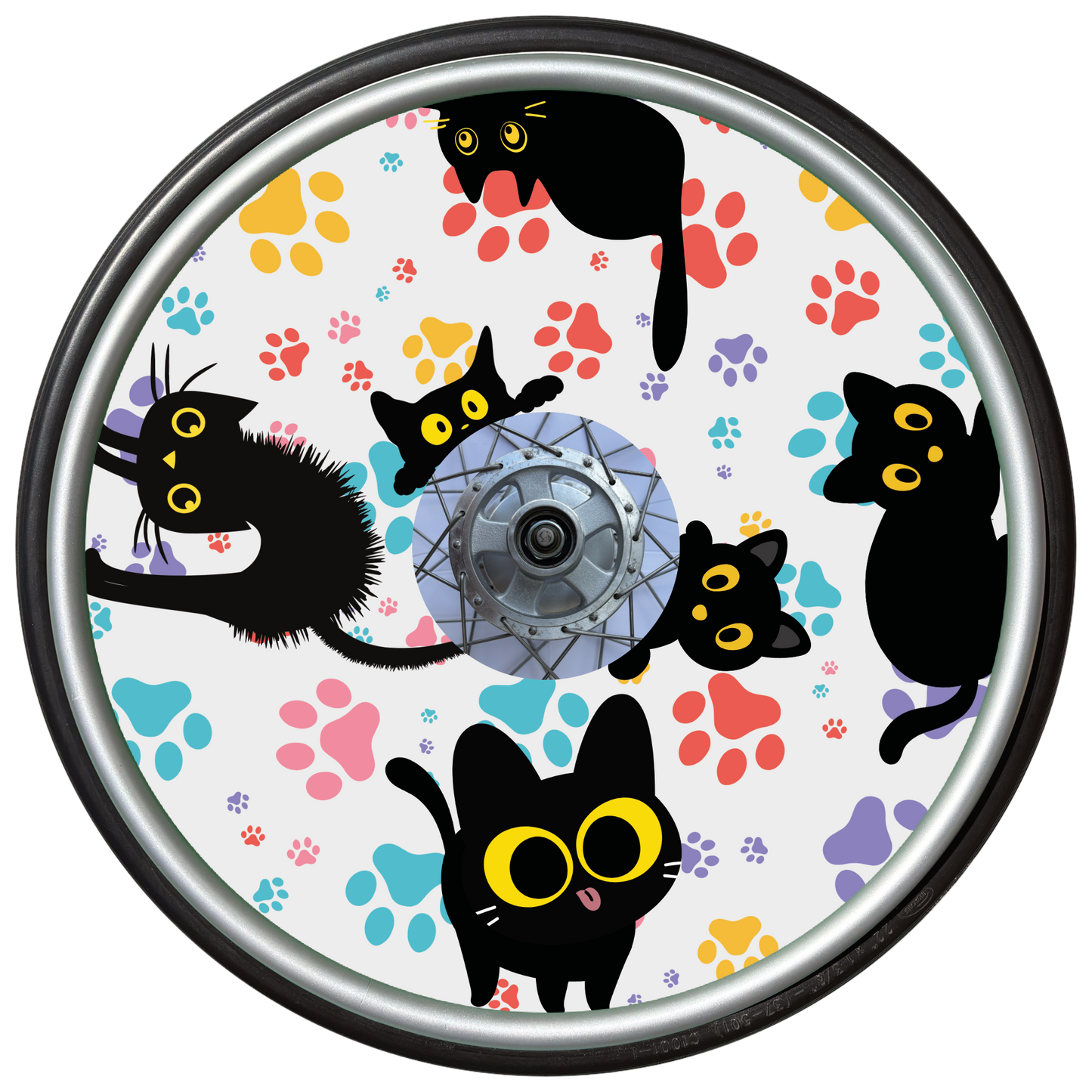Wheelchair wheel cover on a wheel featuring black cats with orange eyes and colourful paw prints on a white background.