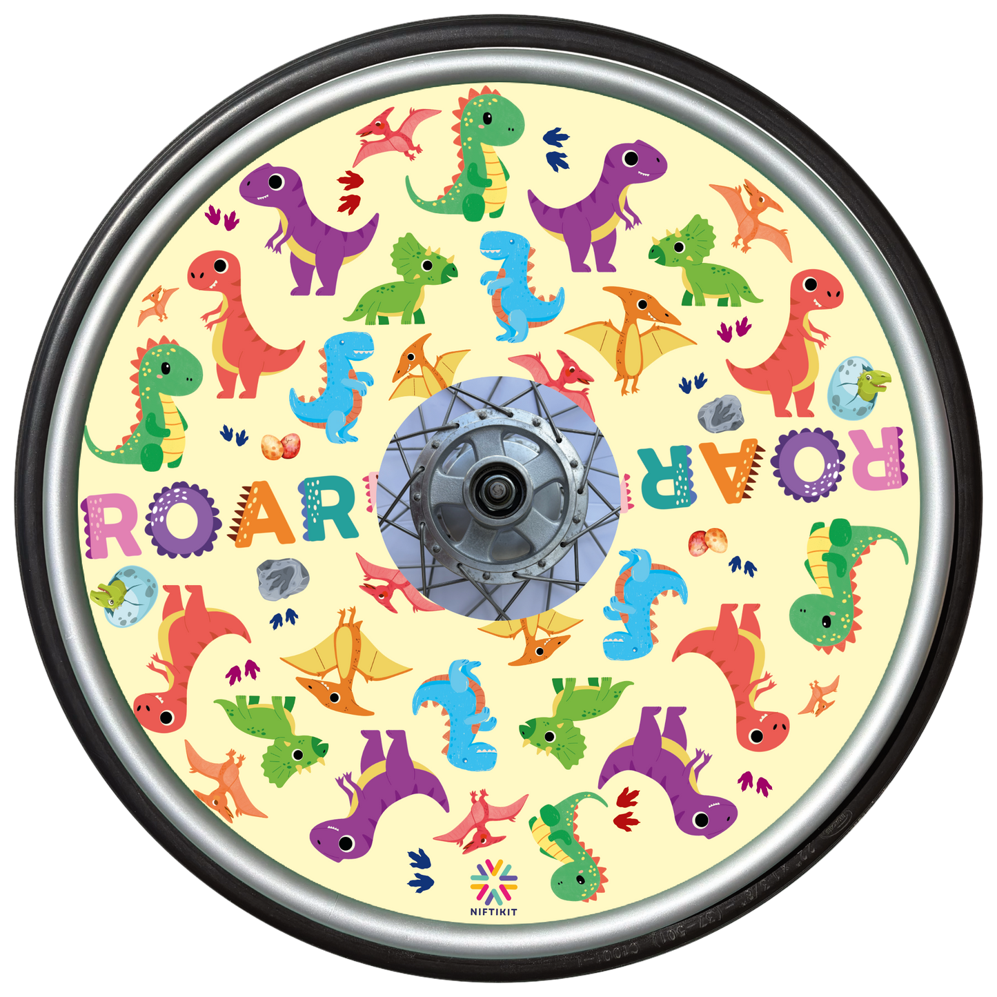 Wheelchair wheel featuring a wheel cover with colorful dinosaur pattern on a cream background