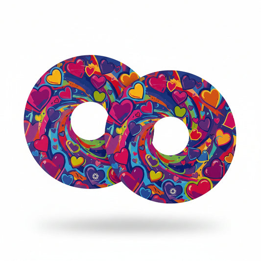 Reversible spoke guards side one shows pink, blue, purple, green, yellow hearts swirling against a purple blue background with Niftikit logo.