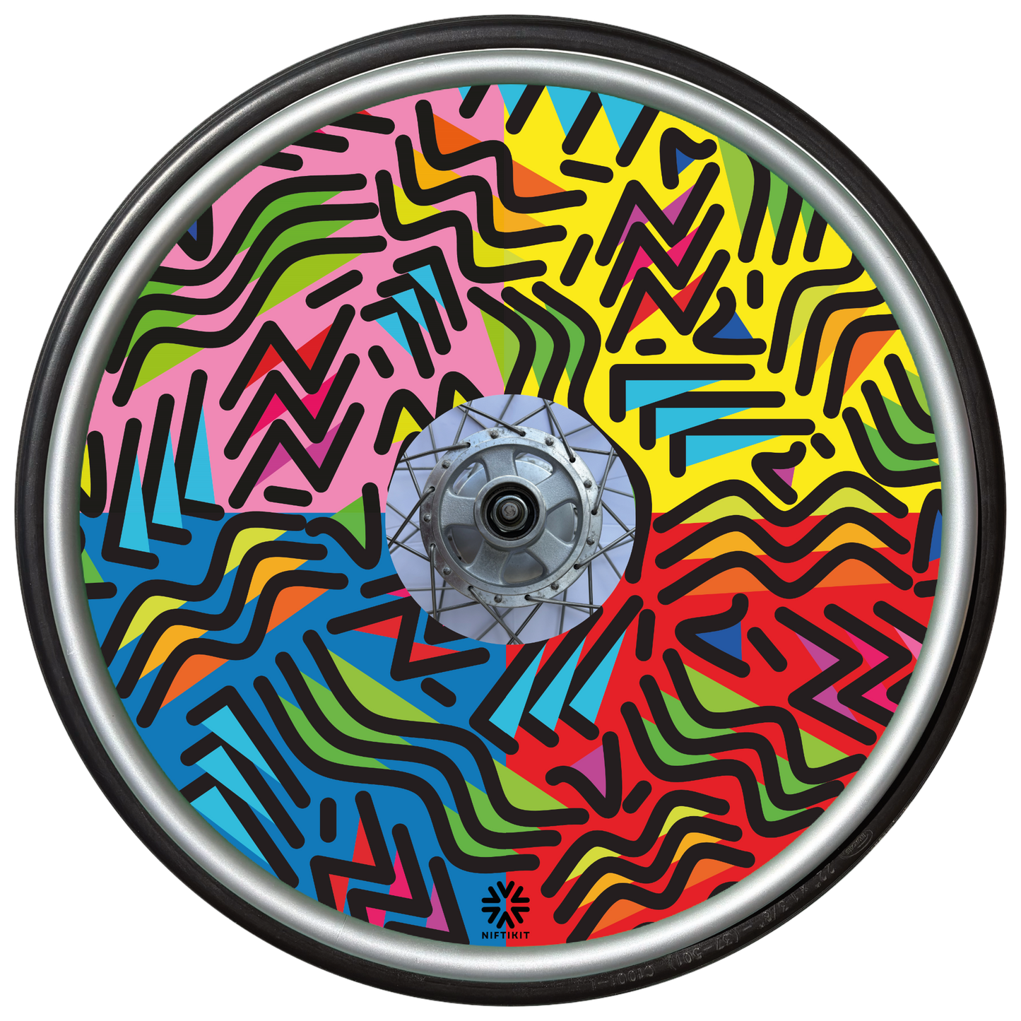 Wheelchair wheel with spoke guard featuring geometric lines of varying shapes and lengths. Background colours of 1/4 pink, 1/4 yellow 1/4 blue, 1/4 red.