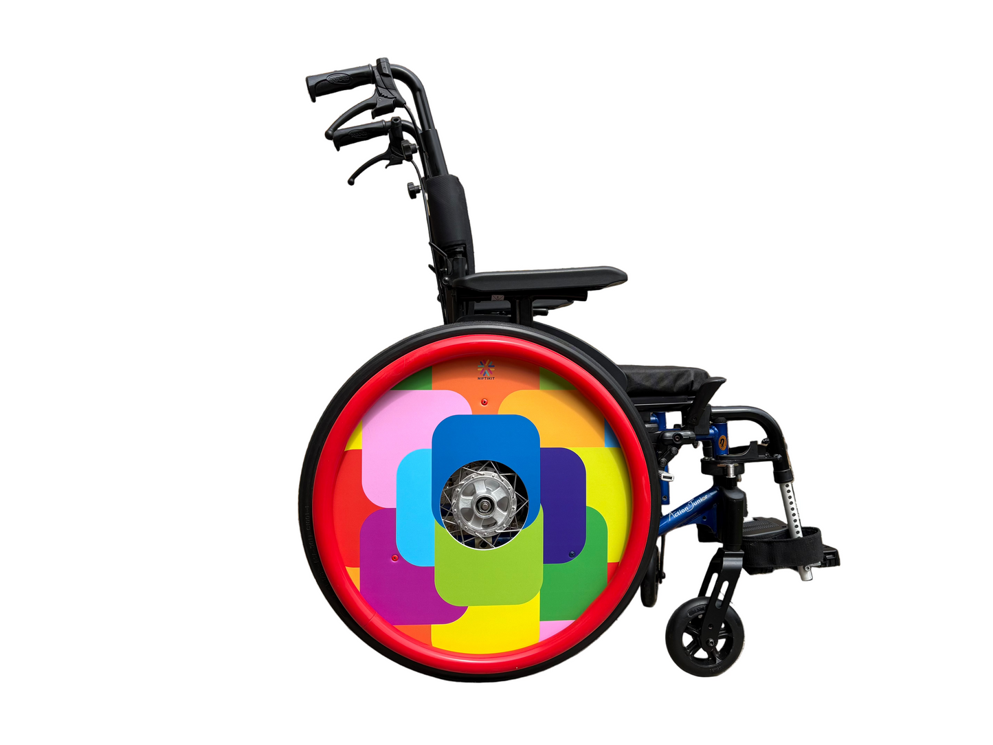 Wheelchair with bright and colorful geometric, squares patterned wheel cover on a wheel with small Niftikit logo. 