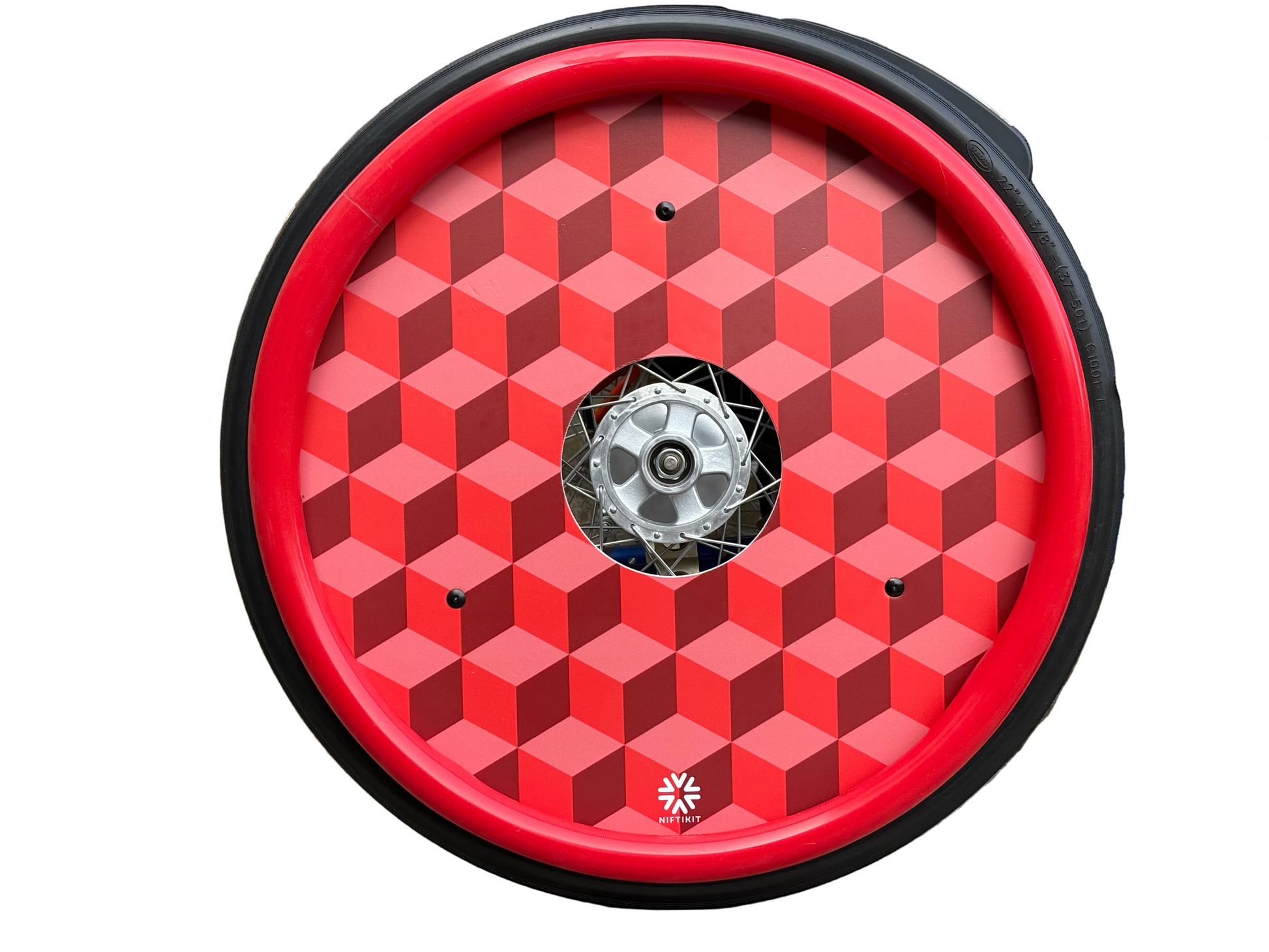 Wheelchair wheel with red spoke guard featuring blocks geometric-pattern with a small white visible Niftikit logo and centre hub cutout.