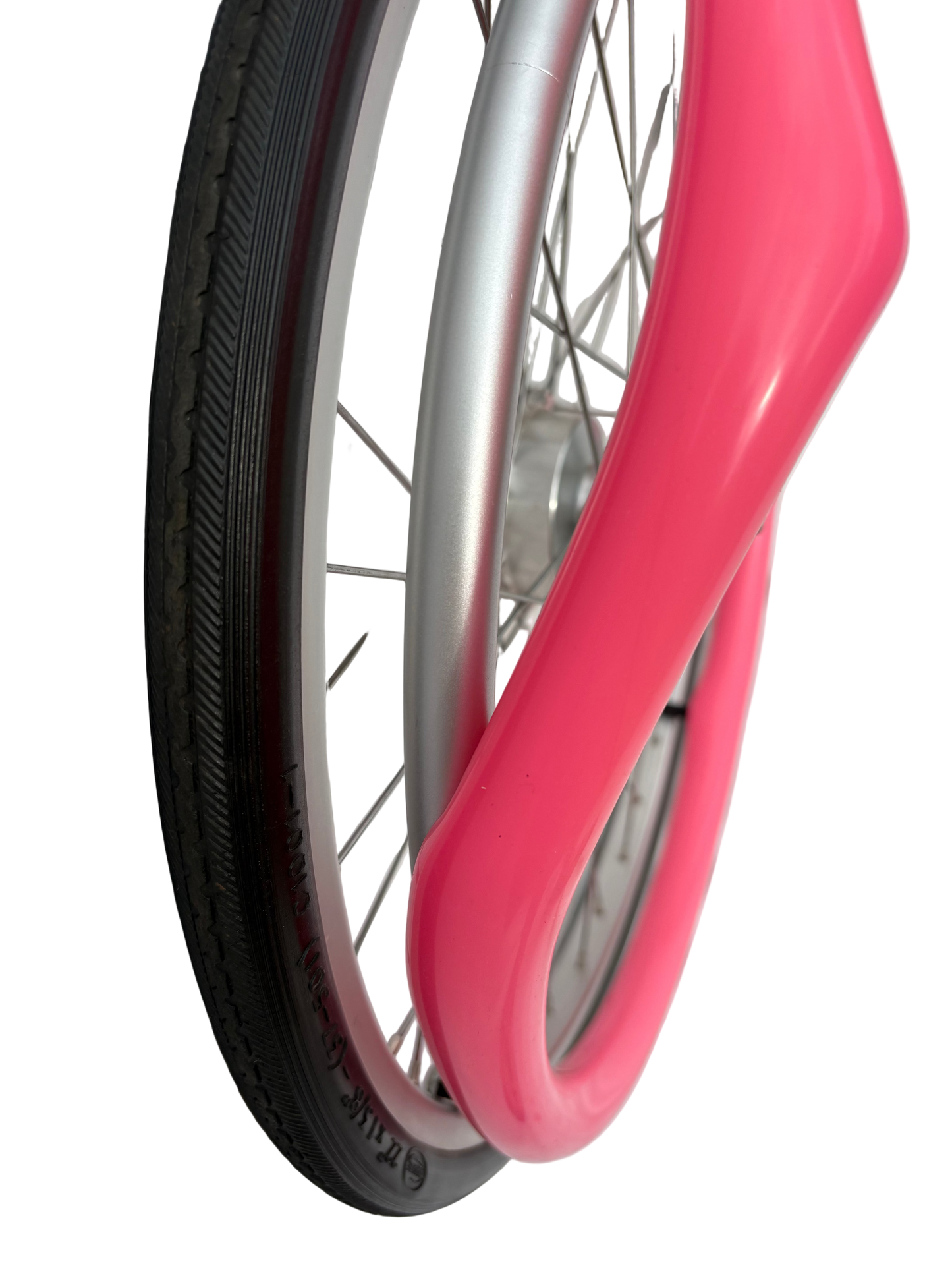 Close up of wheelchair wheel showing removal of pink silicone Handrim cover, Push rim cover