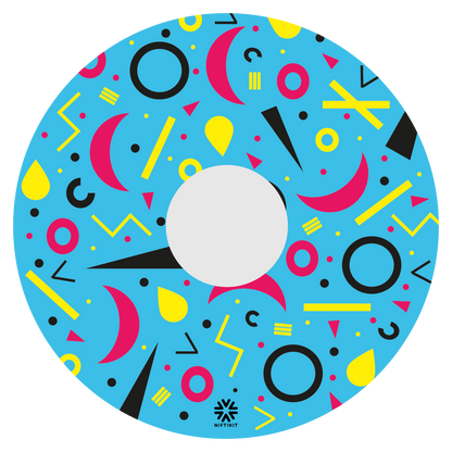 Spoke guard disc with rings, lines  and moons patterns in pink, black, yellow. Centre hub cutout, small Niftikit label. Blue background. 
