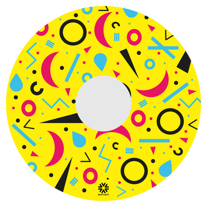 Spoke guard disc with rings, lines  and moons patterns in pink, blue, black. Centre hub cutout, small Niftikit label. Yellow background. 