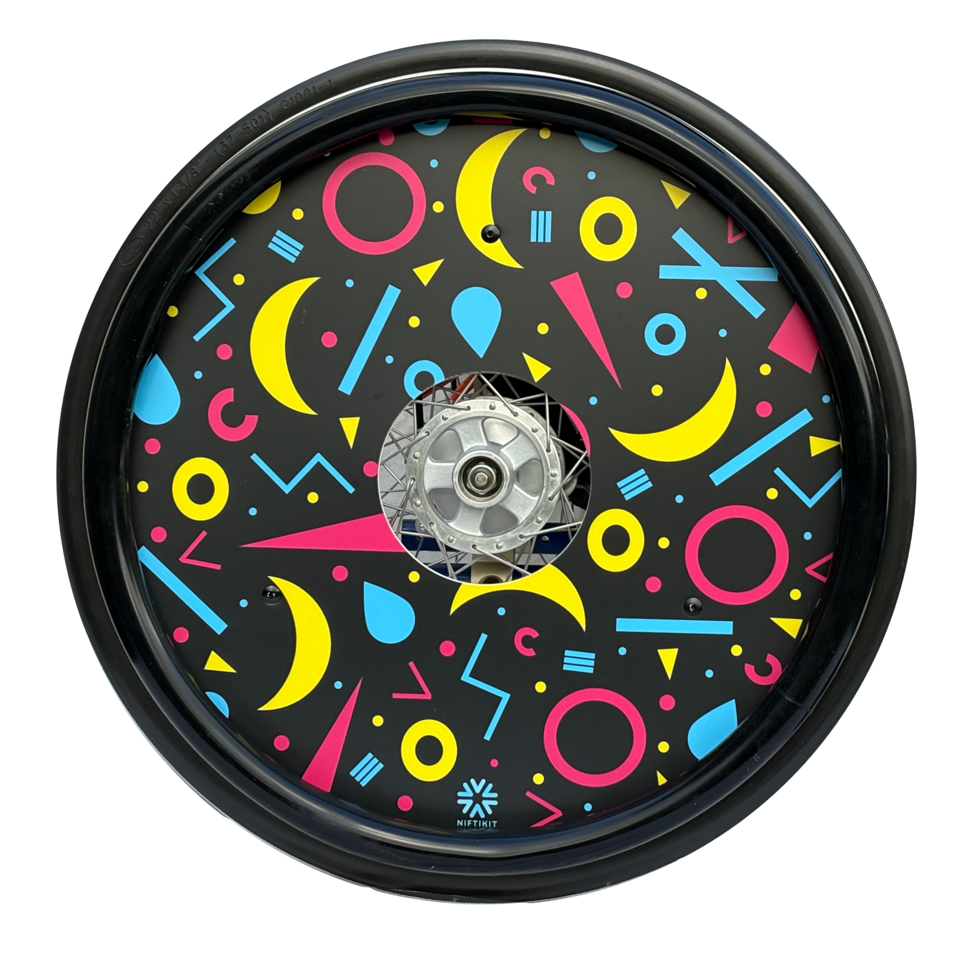 Wheelchair wheel featuring a black silicone hand rim cover and spoke guard with geometric moons, circles and lines on black background