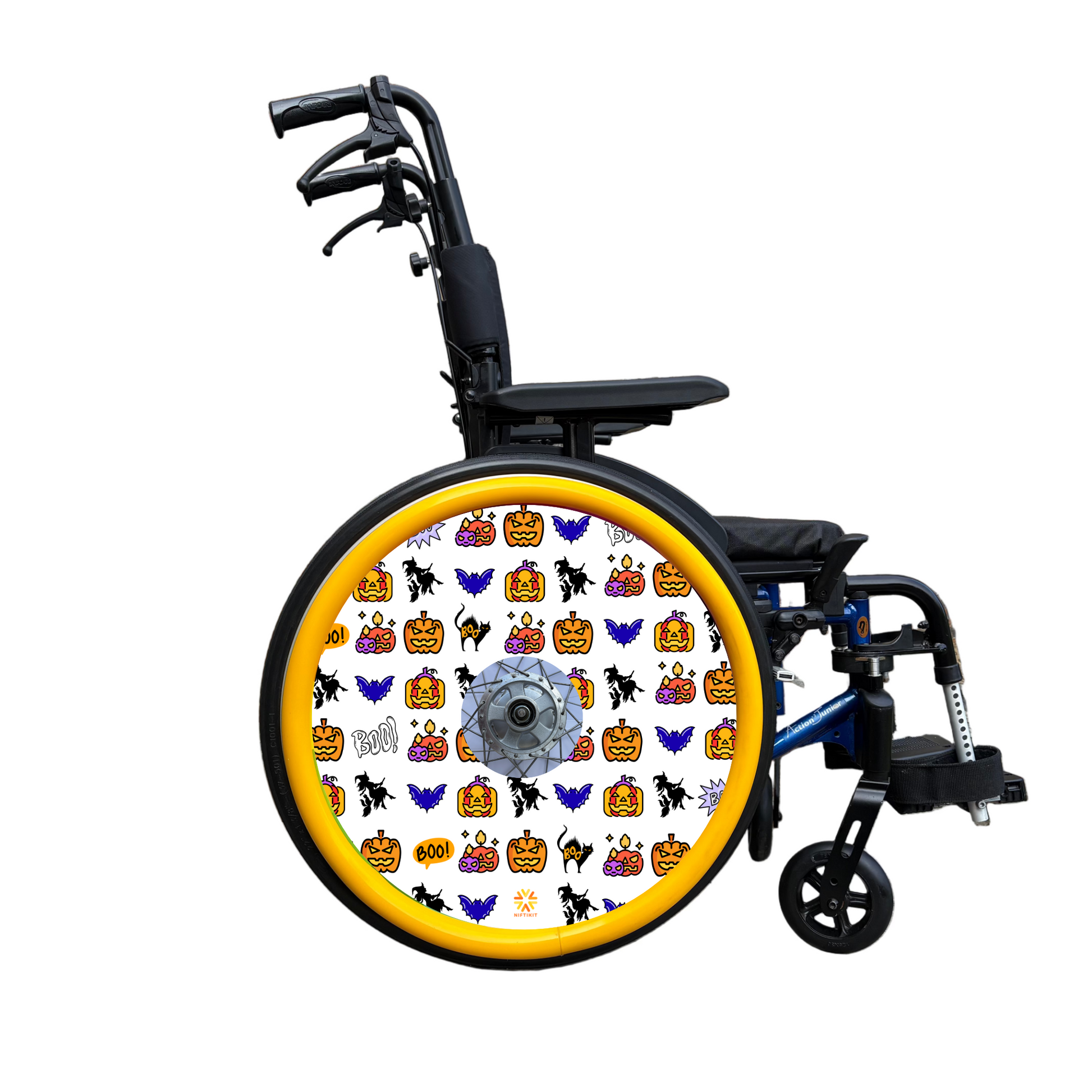 Wheelchair wheel cover on a wheel with orange pushrim covers, Wheel cover features pumpkins, bats, witches and Boo! on a white background.