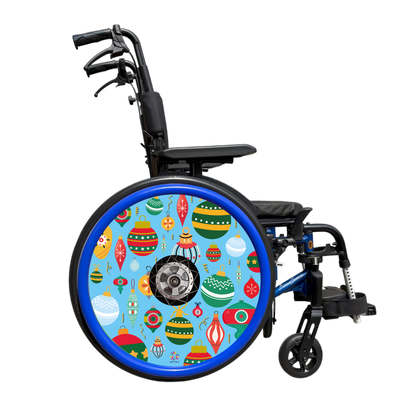 Wheelchair showing wheel cover  of colorful Christmas baubles on a blue background with blue push rim covers 