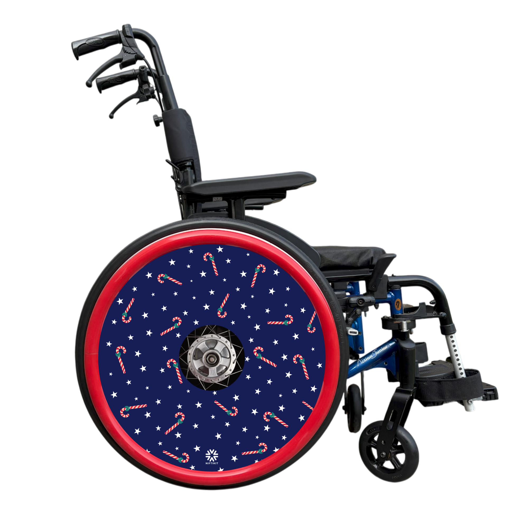 Wheelchair with a decorative wheel cover featuring candy canes and stars on a white background. Finished with a red hand rim cover.