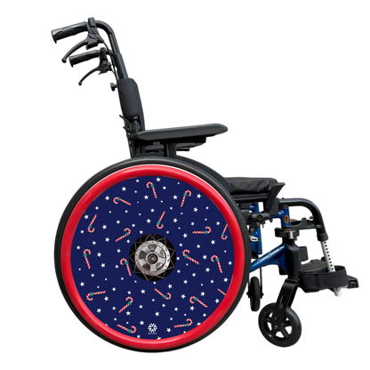 Wheelchair with a decorative wheel cover featuring candy canes and stars on a white background. Finished with a red hand rim cover.