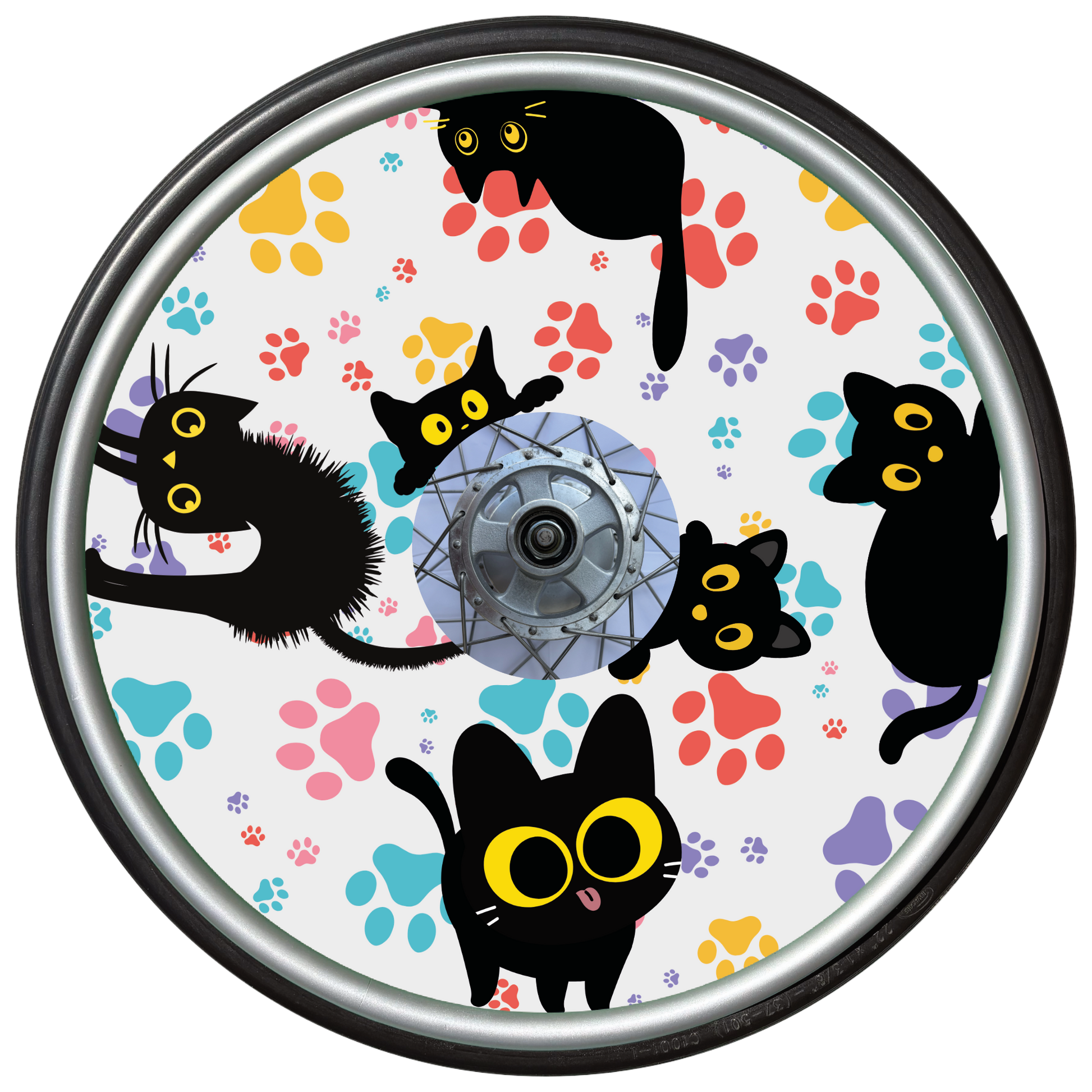 Wheelchair wheel cover on a wheel featuring black cats with orange eyes and colourful paw prints on a white background.