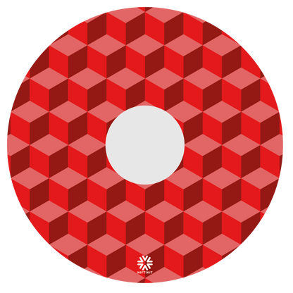 Wheelchair wheel cover with red geometric-blocks pattern with a small white visible Niftikit logo and centre hub cutout.