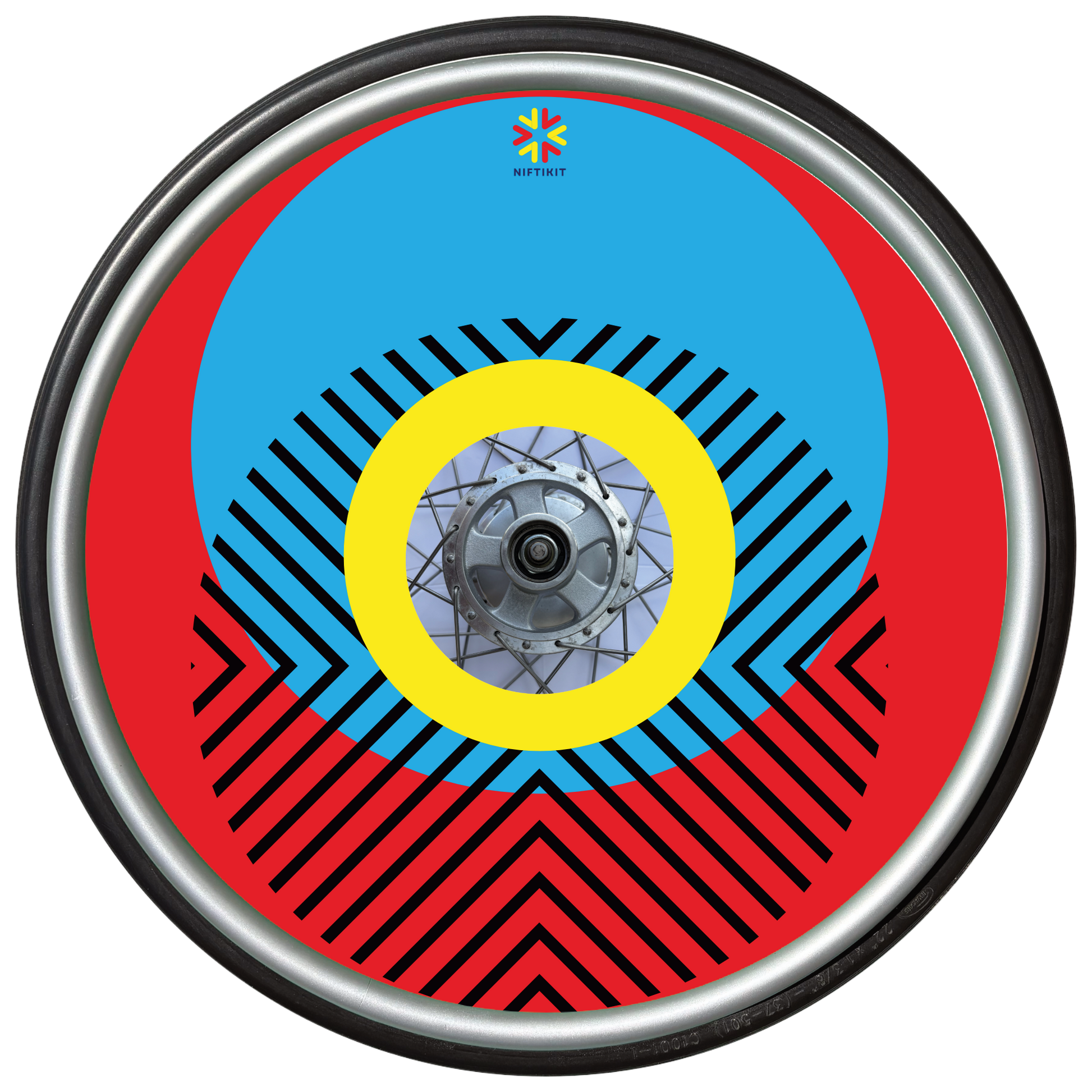 Wheelchair wheel with cover featuring bright geometric pattern including circles and lines. Red background with centre hub cutout and small Niftikit logo.