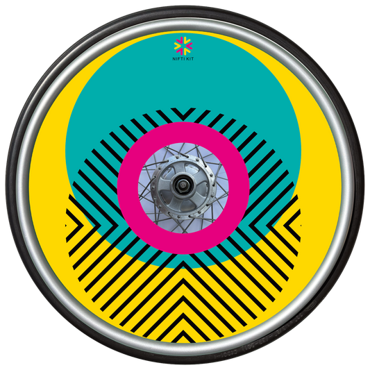 Wheelchair wheel with cover featuring bright geometric pattern including circles and lines. Yellow background with centre hub cutout and small Niftikit logo.