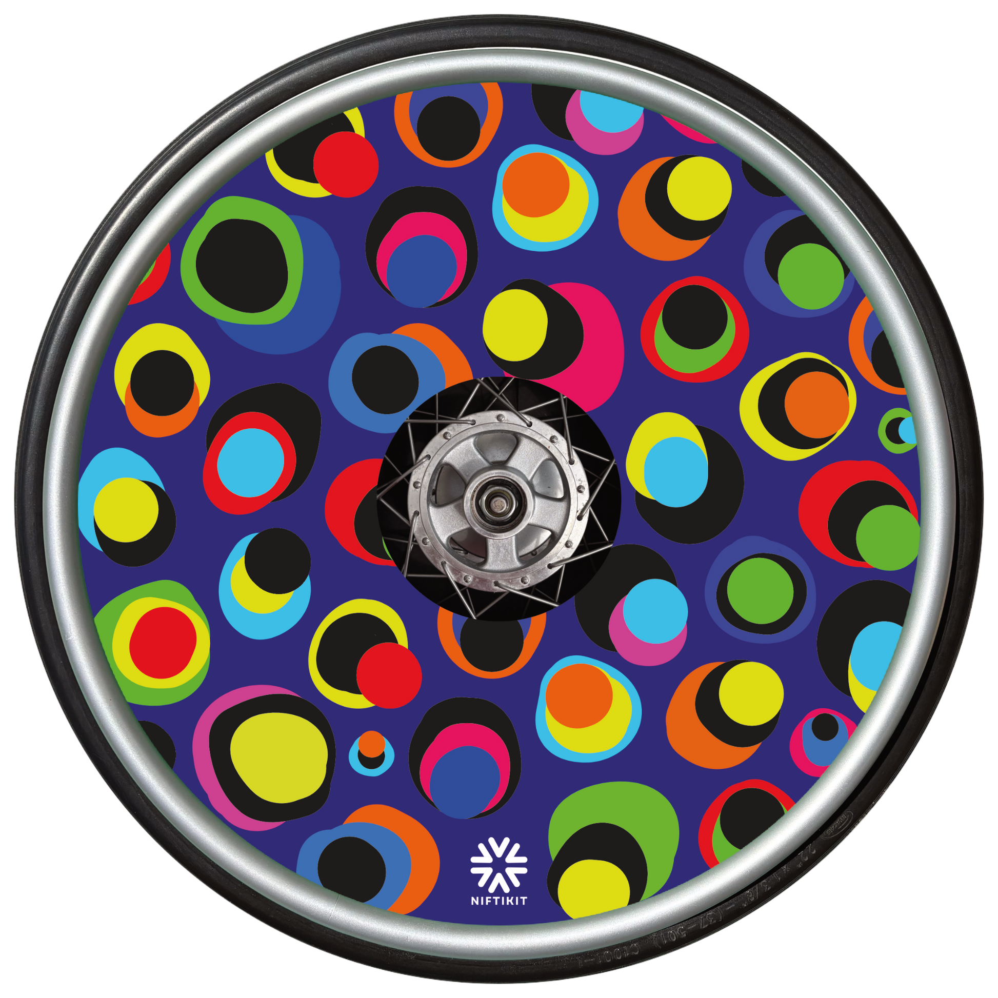 Wheelchair wheel with colourful dot pattern spoke guard covers in bright multicolour circles on a dark blue background, Niftikit Gone Dotty design