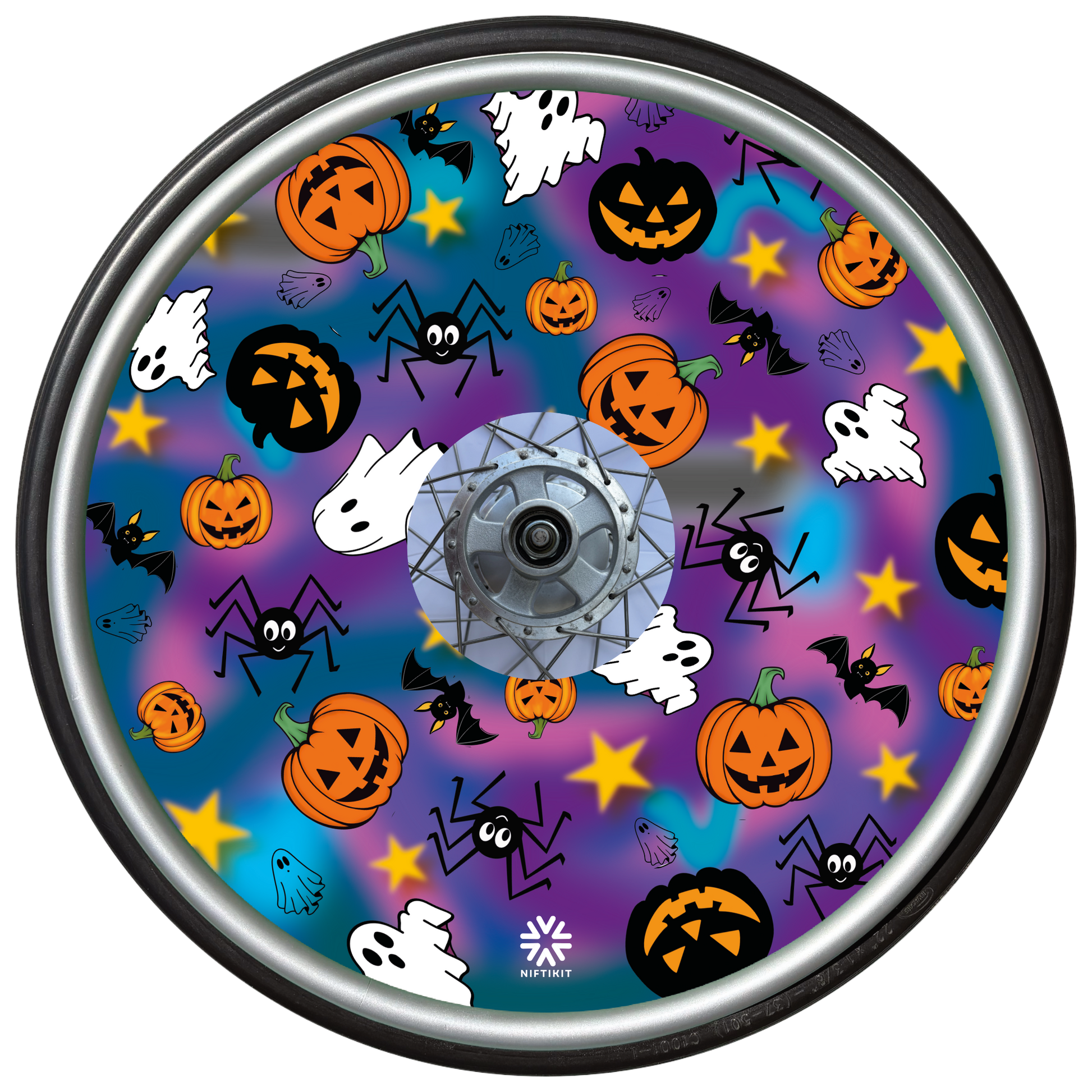 Wheelchair wheel cover on a wheel featuring spiders, ghosts, pumpkins and bats on a blue and purple background.