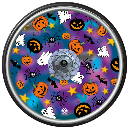 Wheelchair wheel cover on a wheel featuring spiders, ghosts, pumpkins and bats on a blue and purple background.