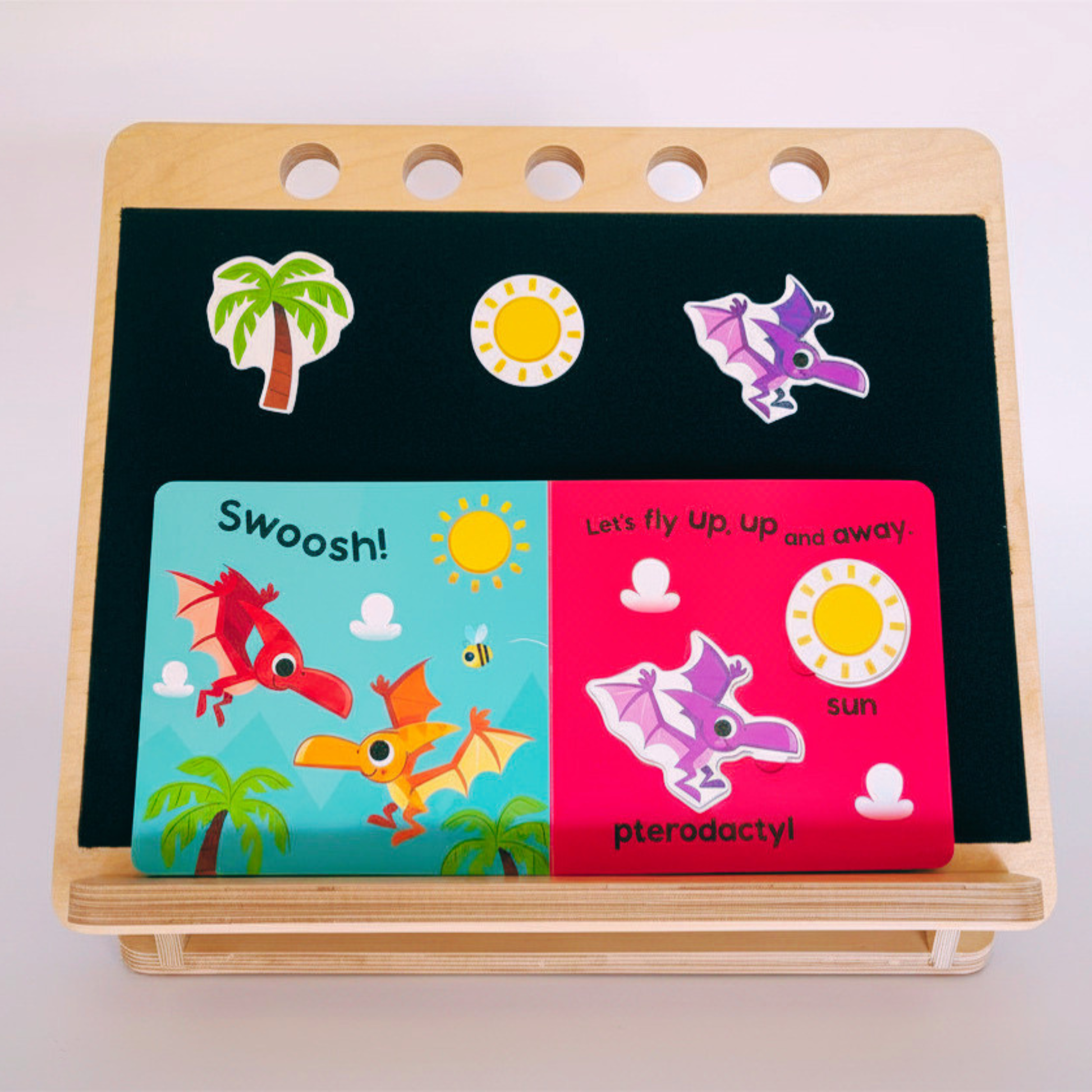 Adults and Children's educational board showing dinosaur illustrations and text on a natural wood desk slope 