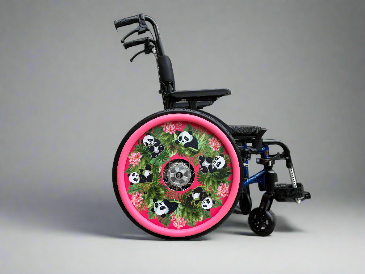 Wheelchair with spoke guard featuring cute panda illustrations, flowers, and leaves on a pink background with matching pink hand rim covers. 