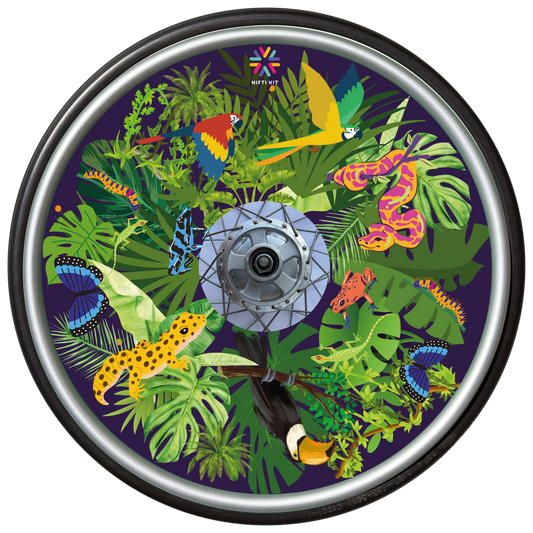 Wheelchair wheel with cover featuring colourful jungle themed animals on various shaped leaves over a navy blue background.  
