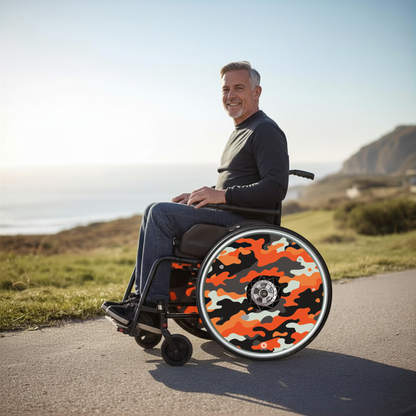 Orange camouflage wheelchair wheel covers fitted to a manual wheelchair used by an older male outdoors, highlighting custom wheelchair spoke guards for wheelchair personalisation, protection and style.