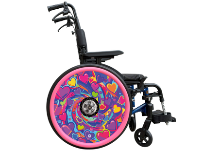 A bright love heart themed swirling design in pinks, purples, yellows and greens. This wheel cover is displayed on a wheelchair with pink silicone hand rim covers (sold separately). 