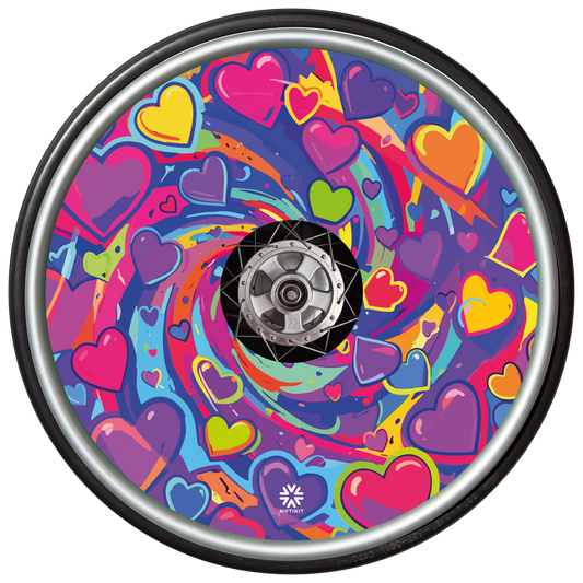 A bright love heart themed swirling design in pinks, purples, yellows and greens. This wheel cover is shown on a wheelchair wheel and includes a small white Niftikit Logo at the bottom 