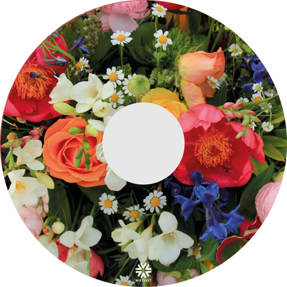 Spoke guard disc featuring an enlarged photo of vibrant British flowers including roses, bluebells, daisy's and mixed foliage. Small white Niftikit logo.  