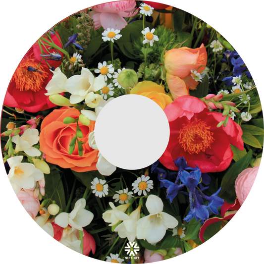 Spoke guard disc featuring an enlarged photo of vibrant British flowers including roses, bluebells, daisy's and mixed foliage. Small white Niftikit logo.  