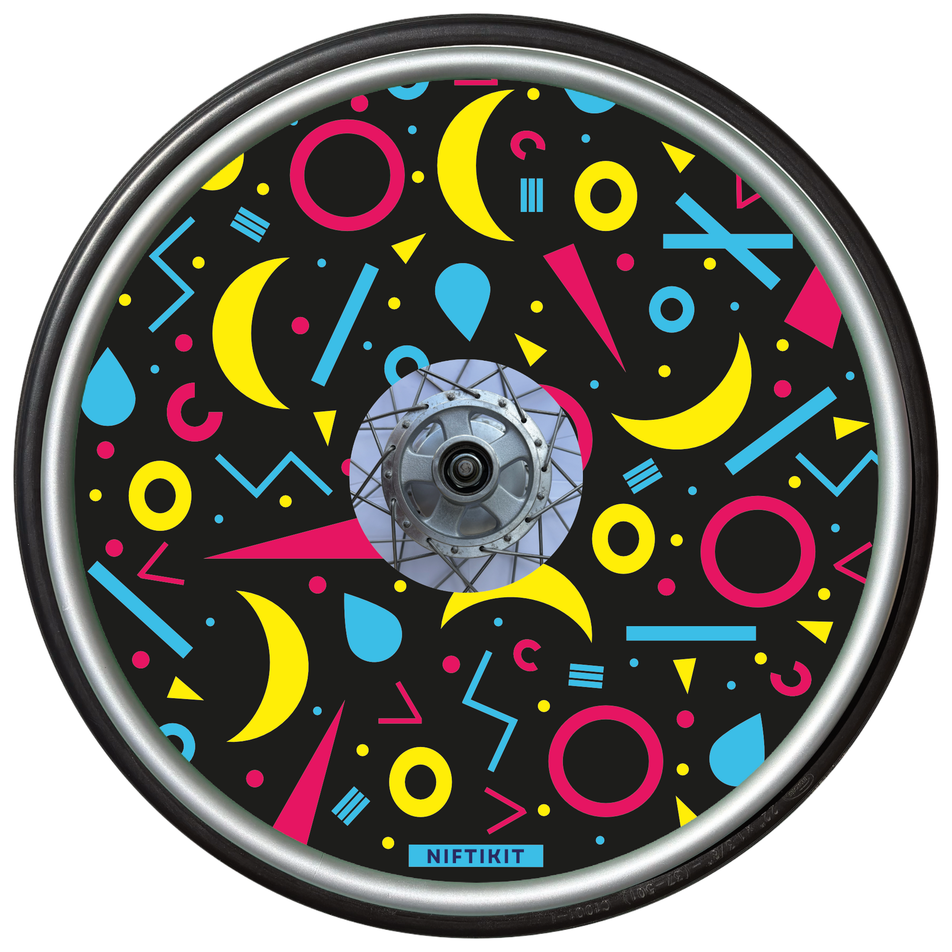 Wheelchair wheel cover with rings, lines  and moons patterns in pink, blue, yellow. Centre hub cutout, small Niftikit label. Black background. 