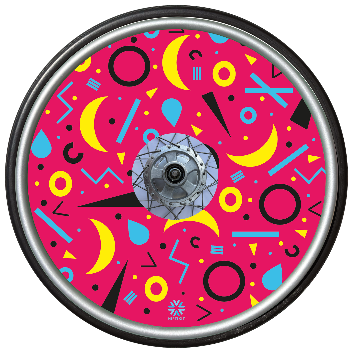 Wheelchair wheel cover with rings, lines  and moons patterns in black, blue, yellow. Centre hub cutout, small Niftikit label. Pink background. 