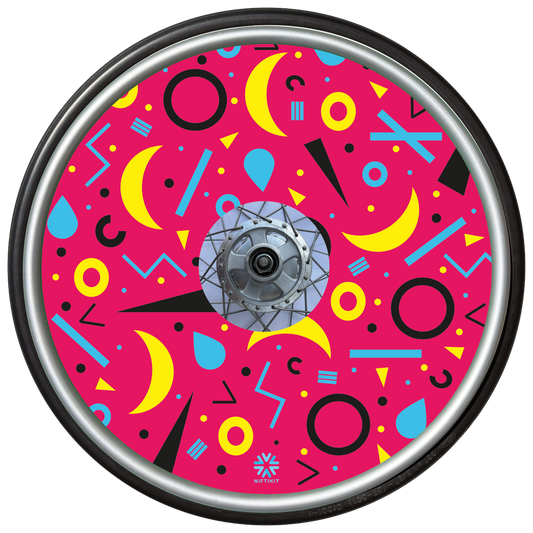 Wheelchair wheel cover with rings, lines  and moons patterns in black, blue, yellow. Centre hub cutout, small Niftikit label. Pink background. 