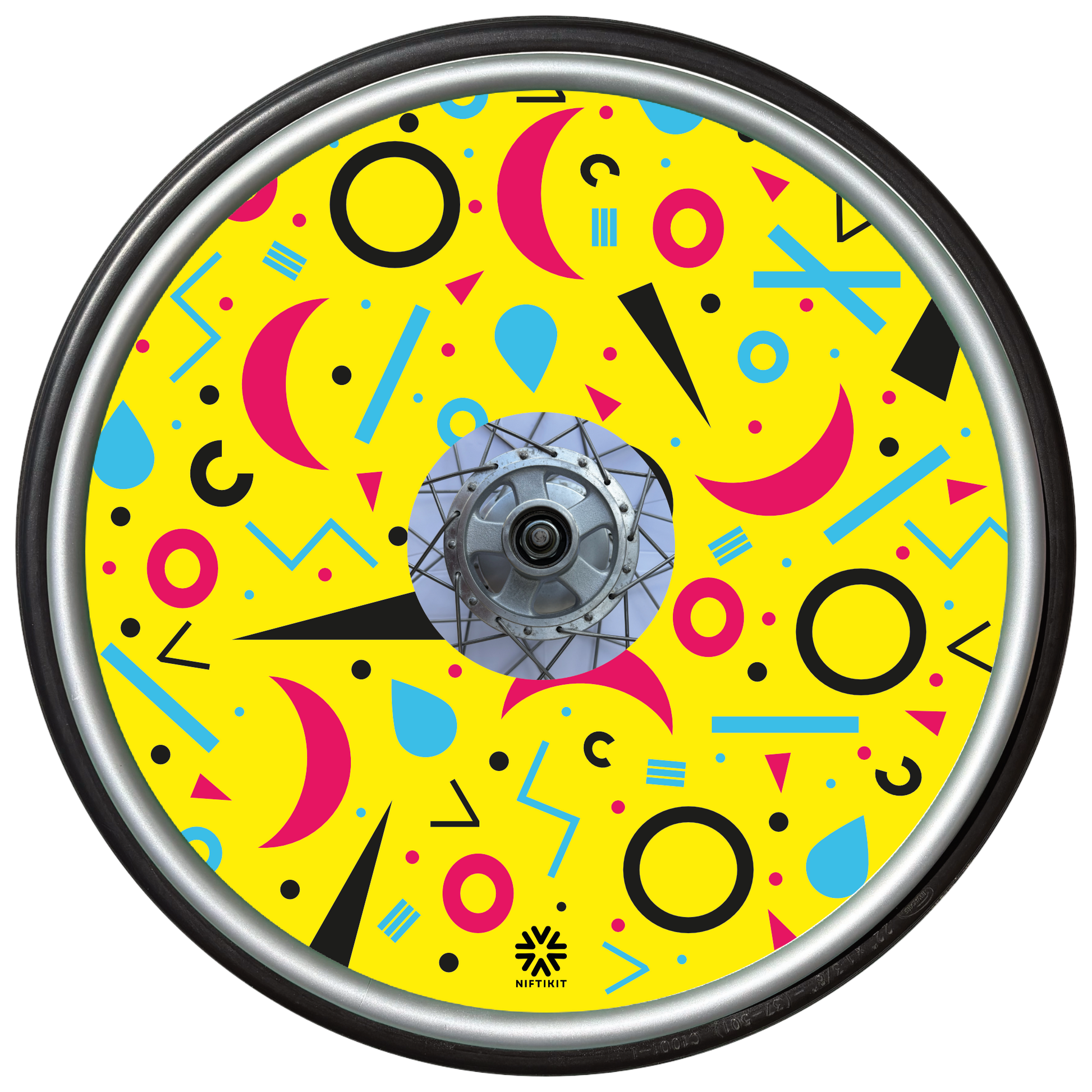 Wheelchair wheel cover with rings, lines  and moons patterns in pink, blue, black. Centre hub cutout, small Niftikit label. Yellow background. 