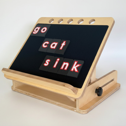 Beautiful wooden desk slope with CVI friendly tactile letter tiles displaying the words 'go cat sink' on a white background