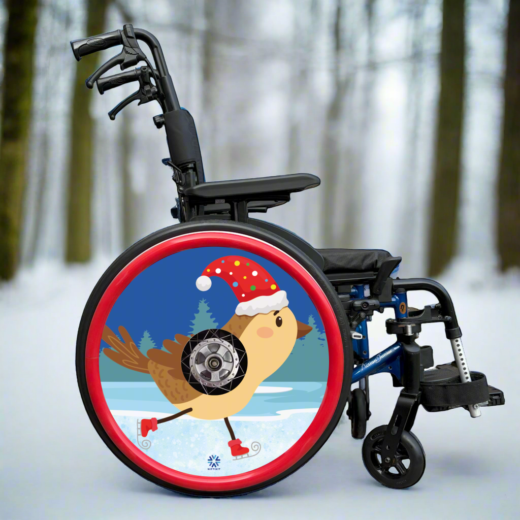 Wheelchair with a decorative wheel  cover featuring a cartoon skating robin wearing a Santa hat in the snow . Finished with a red silicone push rim cover 