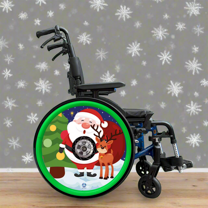 Wheelchair with a Christmas-themed wheel cover featuring colourful Santa Claus and a reindeer on a snowy background finished with green silicone Handrim covers. 