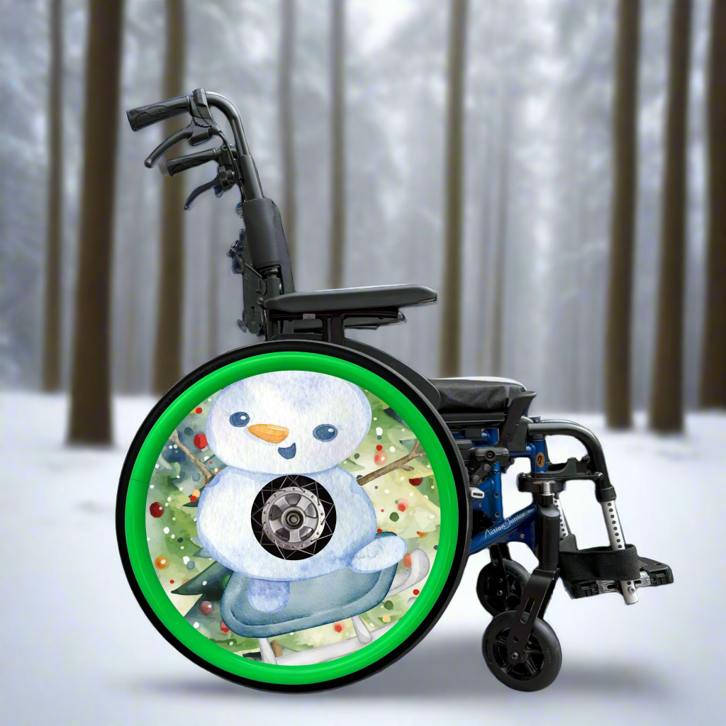 Wheelchair with a festive wheel cover featuring a snowman design on a watercolour Christmas tree background