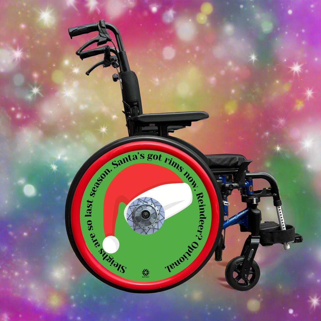 Wheelchair with wheel cover featuring a Santa hat and humorous text on a green background. Chair 