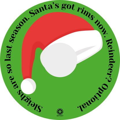 Wheelchair wheel cover with a Santa hat and humorous text on a green background