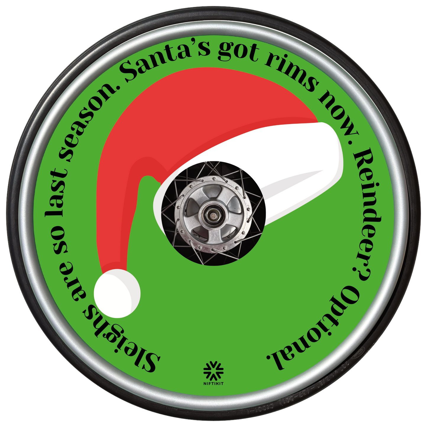 Wheelchair wheel with a Santa hat spoke guard cover and humorous text on a green background