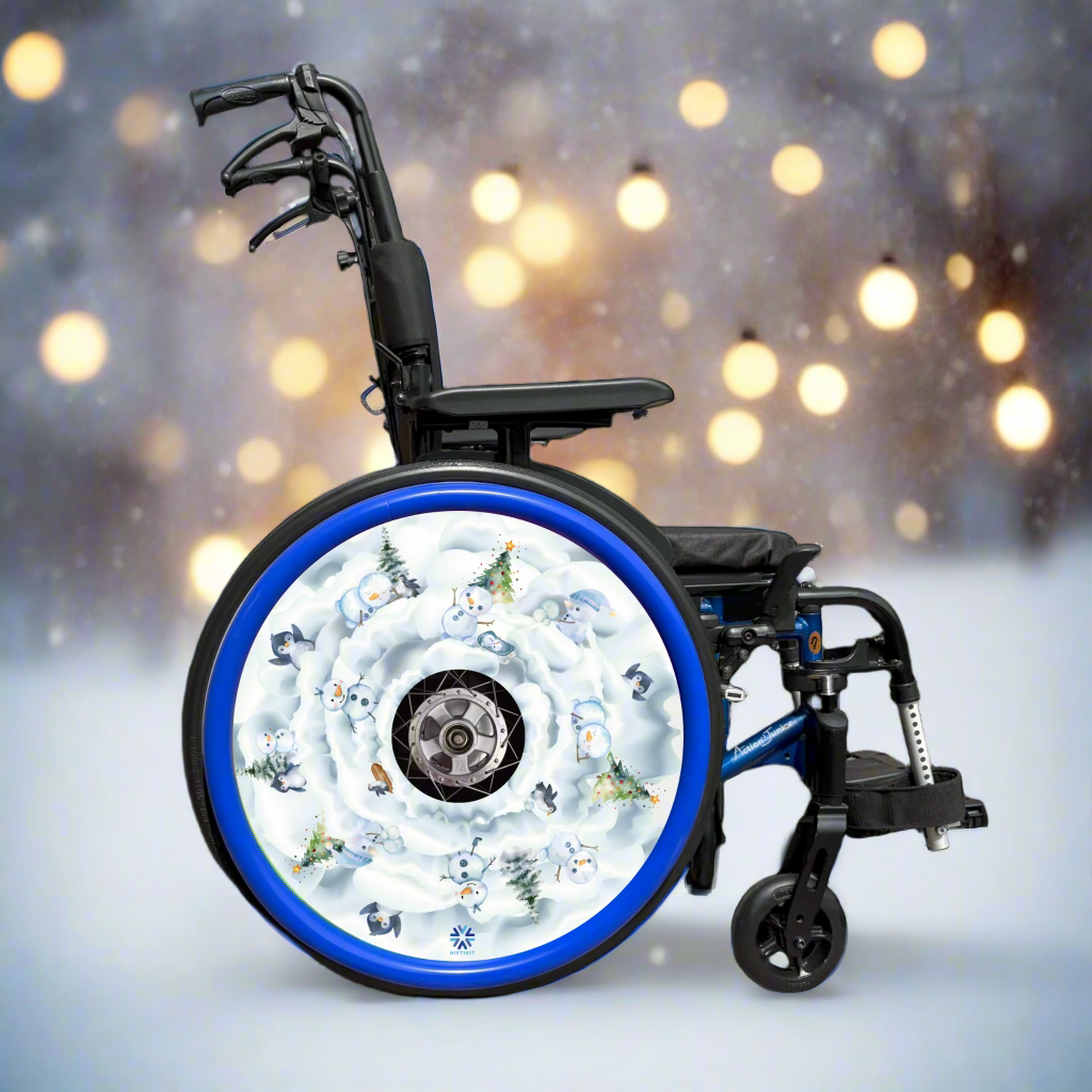 Wheelchair with wheel cover featuring winter, snow-themed design, snowmen and penguins and a blue push rim cover.