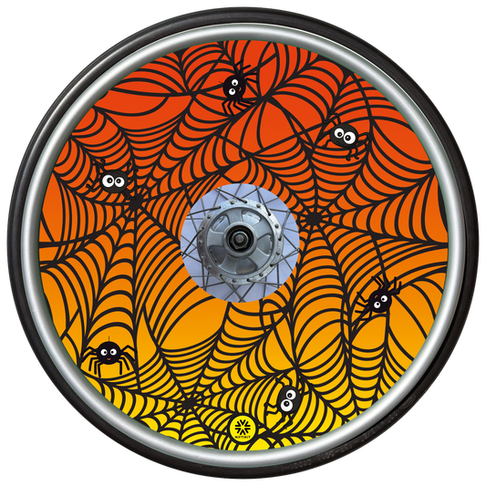 Wheelchair wheel cover on a wheel featuring spiders on spider webs on an orange background.