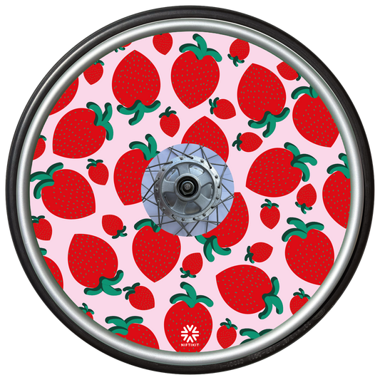 Wheelchair wheel with spoke cover with strawberry pattern on a pink background