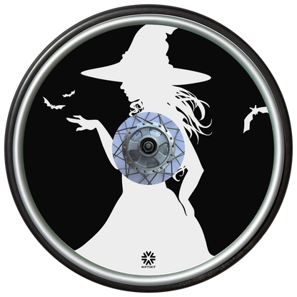 Wheelchair wheel cover on a wheel featuring the white silhouette of a witch and bats on a black background.