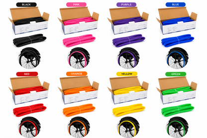 Eight-colour range of silicone wheelchair push rim covers shown fitted to wheelchair wheels, including black, blue, green, orange, pink, purple, red and sunshine yellow handrim covers