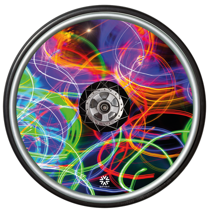 Wheelchair wheel with a spoke guard cover showing bright long exposure colourful light trails and Niftikit LTD logo in white at the bottom. 
