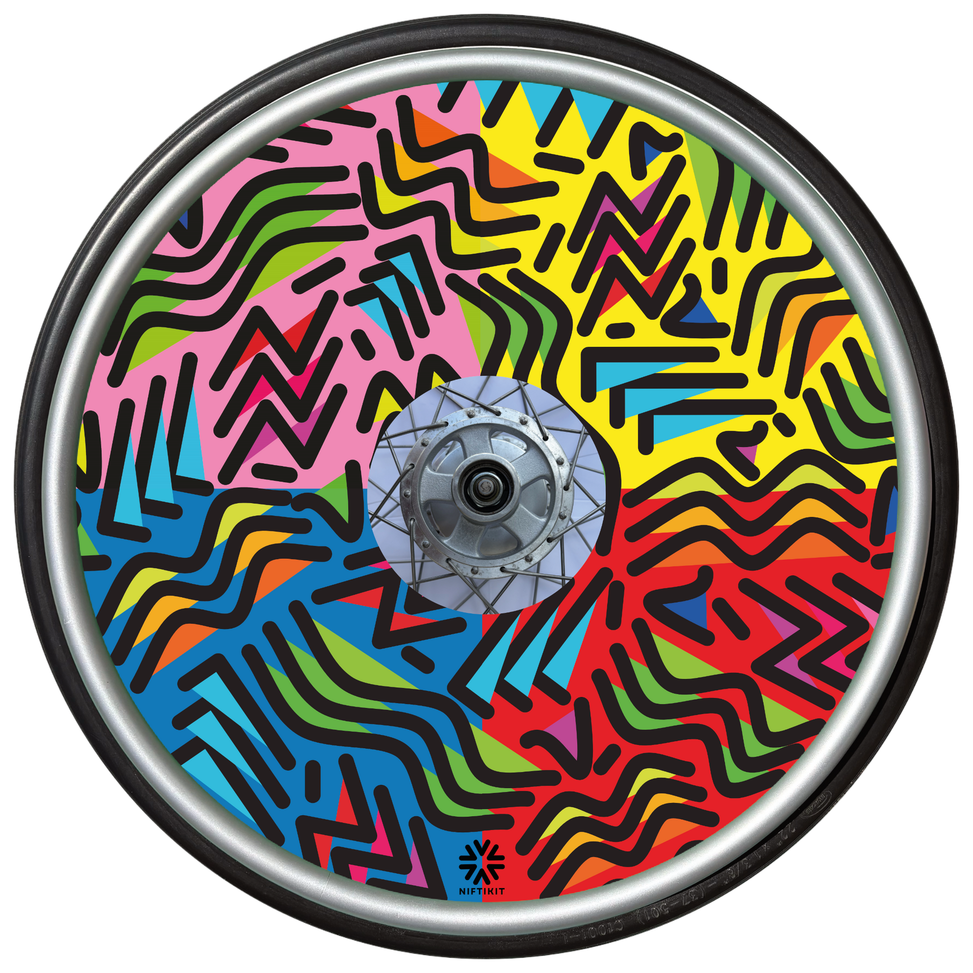 Wheelchair wheel with spoke guard featuring geometric lines of varying shapes and lengths. Background colours of 1/4 pink, 1/4 yellow 1/4 blue, 1/4 red. 