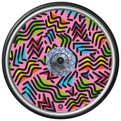 Wheelchair wheel with spoke guard featuring geometric lines of varying shapes and lengths on a pink background 