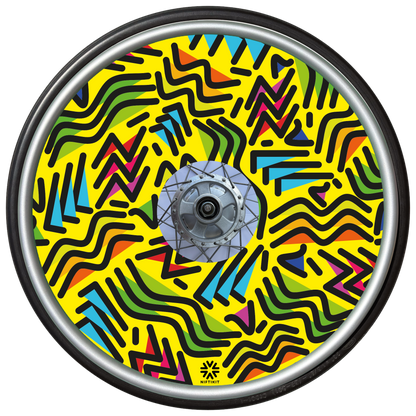 Wheelchair wheel with spoke guard featuring geometric lines of varying shapes and lengths on a yellow background 